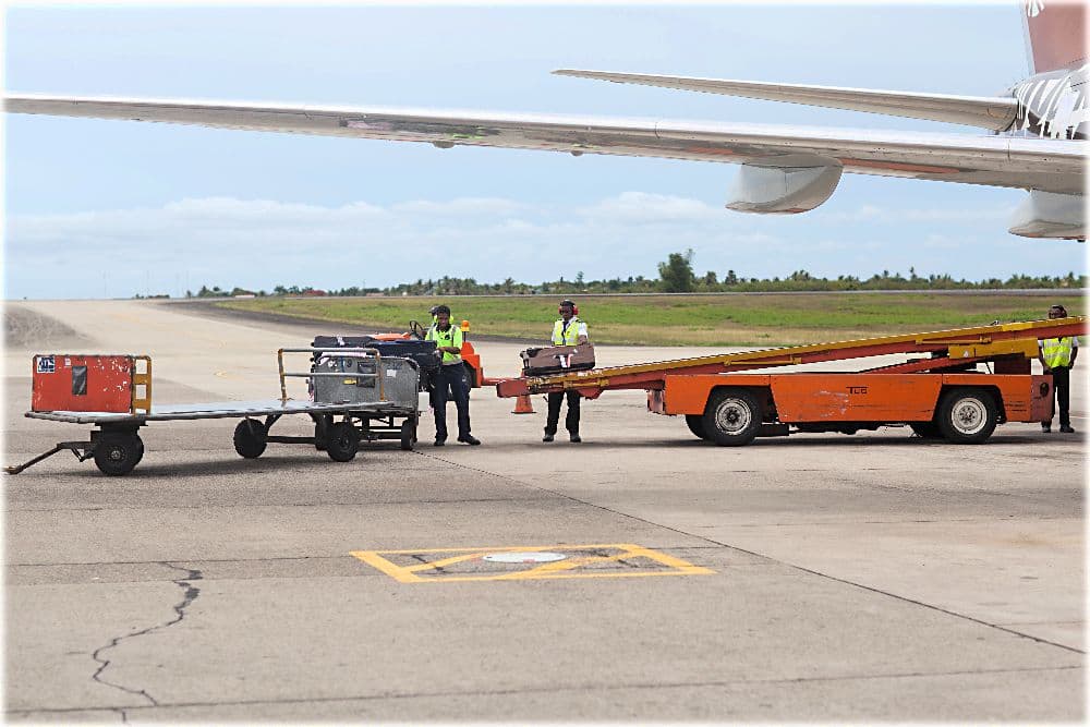 Ramp team working on the tarmac beside a commercial aircraft